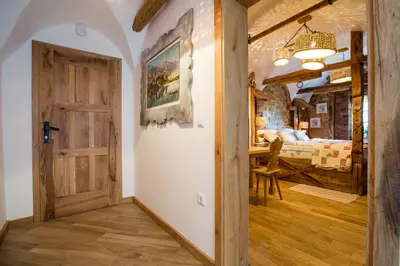 a door leading to a bedroom with a bed at Old Bled House in Bled