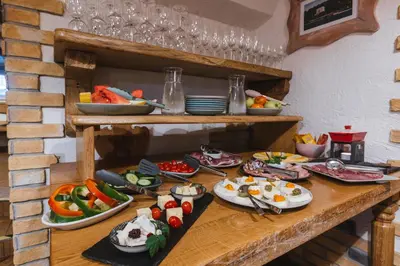 a table with many plates of food on it at Old Bled House in Bled