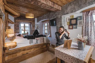 a man talking on a cell phone in a bedroom at Old Bled House in Bled