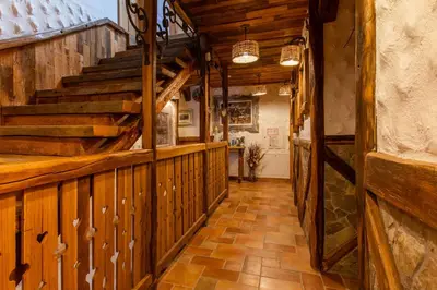 a hallway of a house with wooden walls and stairs at Old Bled House in Bled