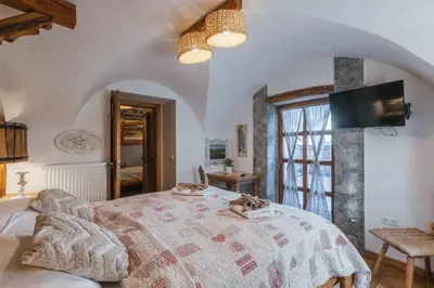 a bedroom with a large bed and a window at Old Bled House in Bled