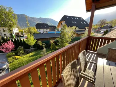 a balcony with chairs and a view of the mountains at ISONZO APARTMENT in Bovec