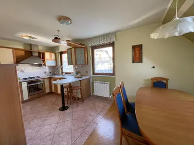 a kitchen and dining room with a table and chairs at ISONZO APARTMENT in Bovec