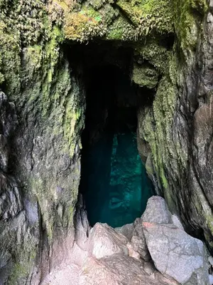 a cave with blue water inside of it at ISONZO APARTMENT in Bovec
