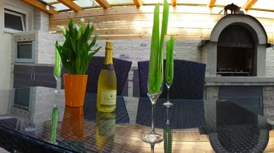 a table with two bottles of wine and glasses on it at Apartment Kanalec in Tolmin