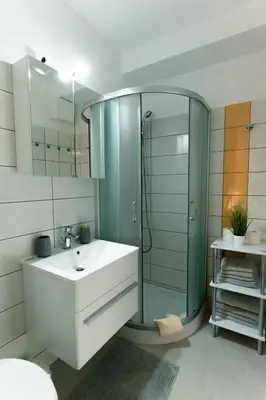 a bathroom with a glass shower and a sink at Apartment Kanalec in Tolmin