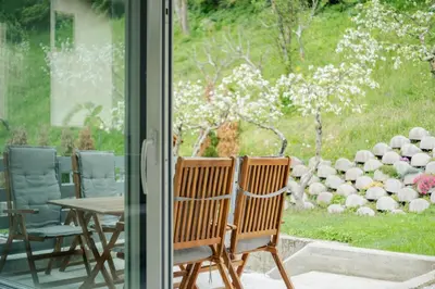 a group of chairs sitting in front of a window at Apartment Kanalec in Tolmin