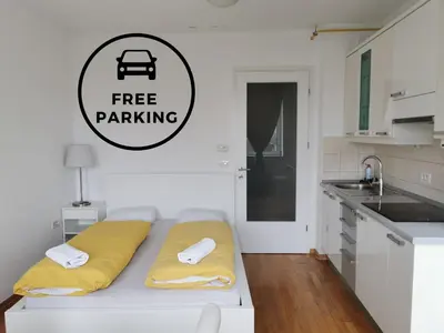 a bed in a kitchen with a free parking sign on the wall at Trnovo apartment with free parking in Ljubljana