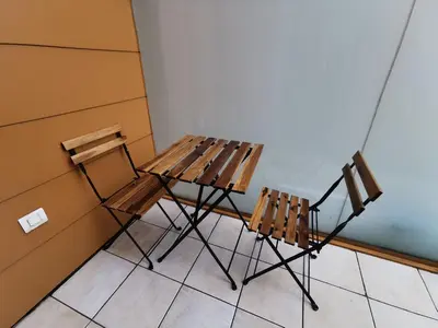 two chairs and a wooden table in a room at Trnovo apartment with free parking in Ljubljana