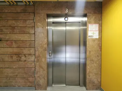 an elevator in a building with a metal door at Trnovo apartment with free parking in Ljubljana