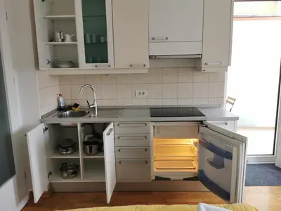 a kitchen with white cabinets and a sink at Trnovo apartment with free parking in Ljubljana