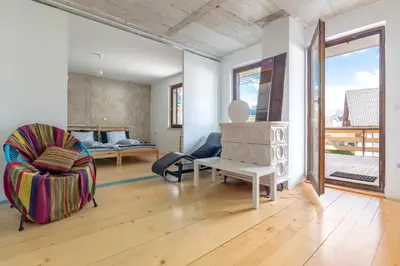 a living room with a couch and a chair at Nature apartment Kersnik in Bohinj