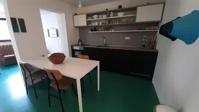 a kitchen with a table and chairs and a sink at Nature apartment Kersnik in Bohinj