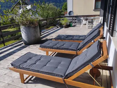 a couple of beds sitting on a patio at Nature apartment Kersnik in Bohinj