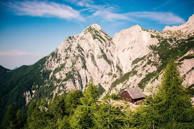 a house in front of a mountain at Homestay Kocka in Zgornje Jezersko