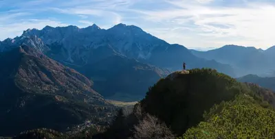 a person standing on top of a mountain at Homestay Kocka in Zgornje Jezersko