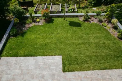a lawn with two benches in a garden at Apartment Oddih in Bled