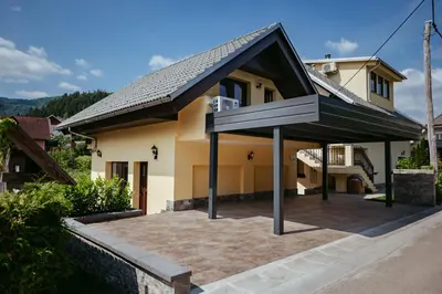 a house with a roof that has a patio at Apartment Oddih in Bled