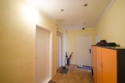 a room with a hallway with a white door and a cabinet at Apartment Tržaška with free parking in Ljubljana