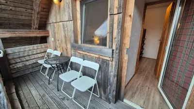 a patio with a table and chairs on a porch at Apartments Čebelica in Bohinj