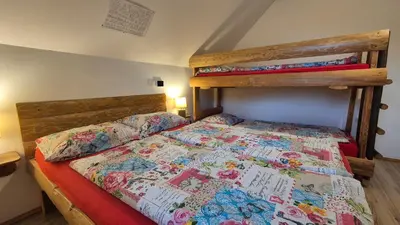 a bedroom with a bed and a bunk bed at Apartments Čebelica in Bohinj