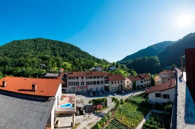 a view of a town with mountains in the background at Apartma Most in Most na Soči