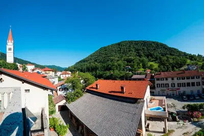 a view of a town with a mountain in the background at Apartma Most in Most na Soči