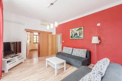 a living room with a couch and a tv at Apartma Most in Most na Soči