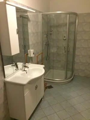 a bathroom with a sink and a shower at Guest house Okrepčevalnica Zemonska vaga in Ilirska Bistrica