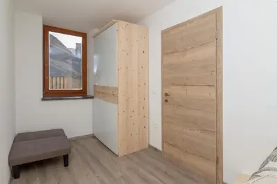a bedroom with a sliding door and a window at Old Mill House in Bohinj