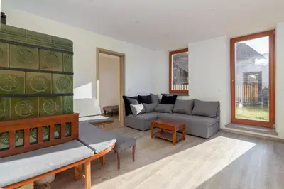 a living room with a couch and a table at Old Mill House in Bohinj