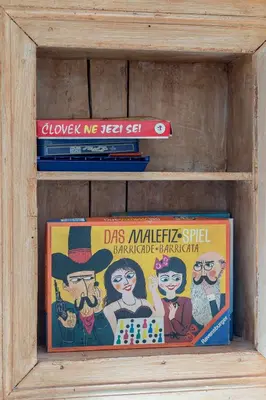 a stack of books in a wooden shelf at Old Mill House in Bohinj