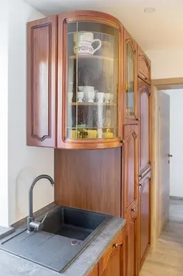 a kitchen with a sink and a wooden cabinet at Old Mill House in Bohinj
