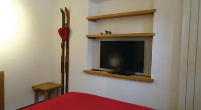 a living room with a tv on a wall at Apartma Pri Štruklju in Kranjska Gora