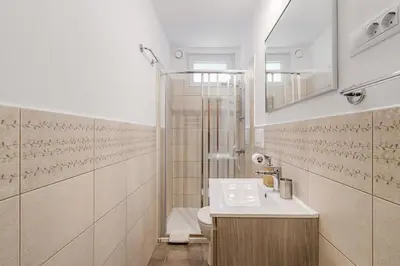 a bathroom with a sink and a toilet and a shower at Hisa Taljat in Most na Soči
