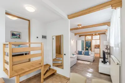 a room with a bunk bed and a living room at Hisa Taljat in Most na Soči