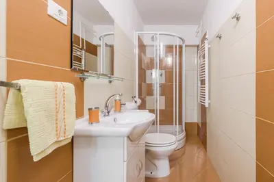 a bathroom with a toilet and a sink at Hisa Taljat in Most na Soči
