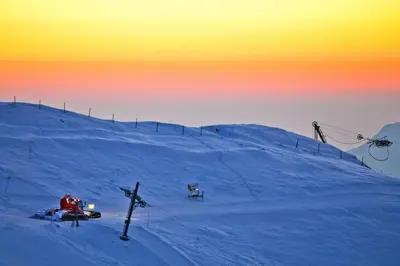 a snow covered hill with a ski lift on it at Brunarica in Bohinj