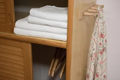 a stack of towels on a shelf in a bathroom at Brunarica in Bohinj