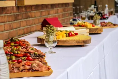 a long table with several plates of food on it at Slovenia Eco resort in Stahovica