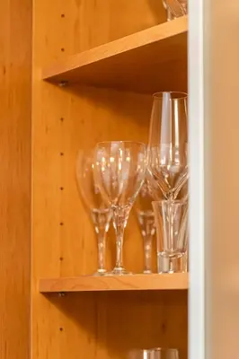 a row of wine glasses on a shelf at Apartma BRINA, new bathroom in nov 24 in Kranjska Gora