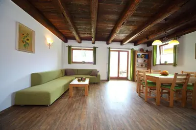 a living room with a couch and a table at Pod Ponco Apartments in Kranjska Gora