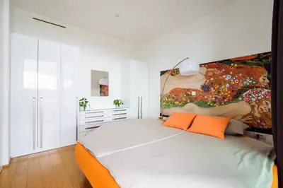 a bedroom with a bed and a painting on the wall at Slovenia Crib in Ljubljana