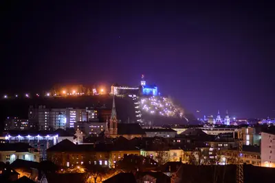 a view of a city at night with lights at Slovenia Crib in Ljubljana