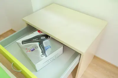 a white table with a tool in a drawer at Sport Hotel Ljubljana in Ljubljana