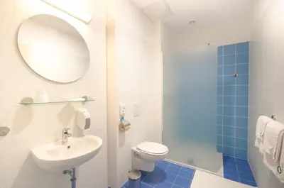 a bathroom with a toilet and a sink and a mirror at Sport Hotel Ljubljana in Ljubljana