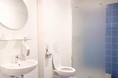 a bathroom with a white toilet and a sink at Sport Hotel Ljubljana in Ljubljana