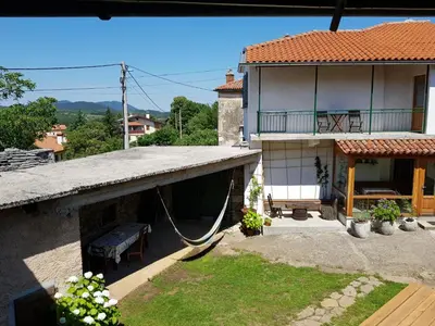 a house with a porch with a swing at Vila Dane in Sežana