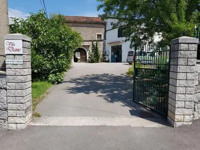 a gate with a sign that reads walk zone at Vila Dane in Sežana