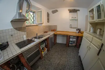 a small kitchen with a sink and a counter at Vila Dane in Sežana